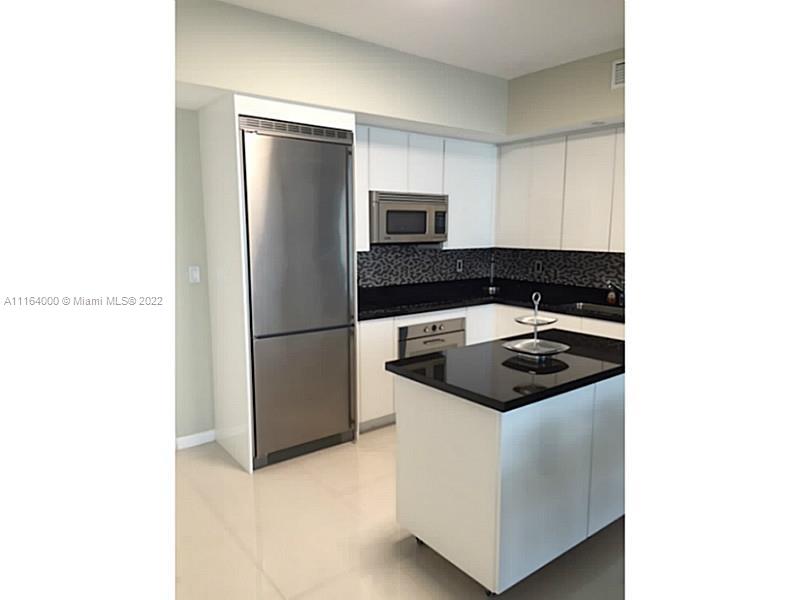 92 Southwest 3rd Street, Unit 2911 Miami, FL 33130 - Photo 2 of 16 a kitchen with a stove and a refrigerator