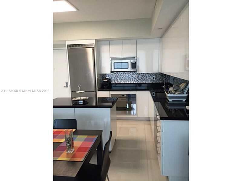 92 Southwest 3rd Street, Unit 2911 Miami, FL 33130 - Photo 3 of 16 a kitchen with a stove and a refrigerator