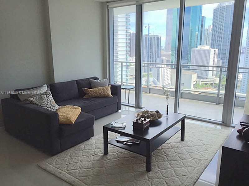 92 Southwest 3rd Street, Unit 2911 Miami, FL 33130 - Photo 5 of 16 a living room with furniture and a window