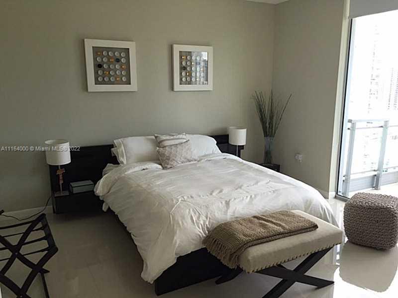92 Southwest 3rd Street, Unit 2911 Miami, FL 33130 - Photo 6 of 16 a bedroom with a bed and a window