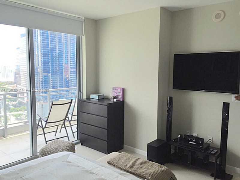 92 Southwest 3rd Street, Unit 2911 Miami, FL 33130 - Photo 8 of 16 a bedroom with a bed and a television in it