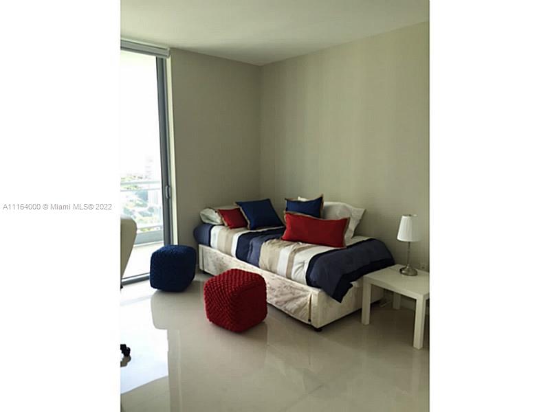 92 Southwest 3rd Street, Unit 2911 Miami, FL 33130 - Photo 9 of 16 a bedroom with a bed and a window