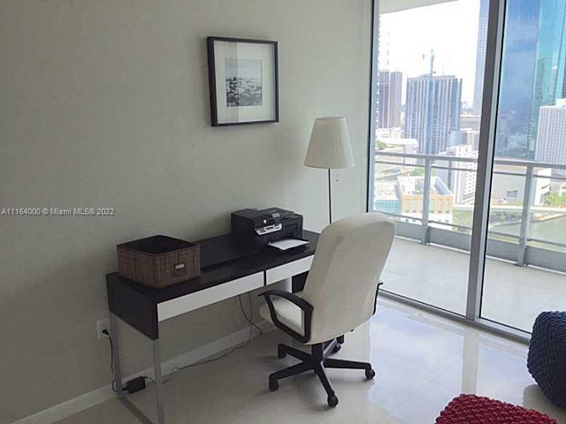92 Southwest 3rd Street, Unit 2911 Miami, FL 33130 - Photo 10 of 16 a view of a workspace with furniture and a window