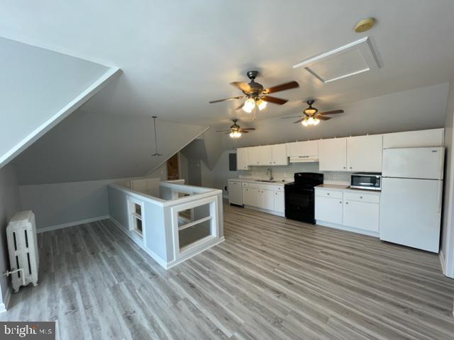 1122 Caroline Street, Unit 4 Fredericksburg, VA 22401 - Photo 5 of 15 a kitchen with stainless steel appliances a stove top oven and cabinets
