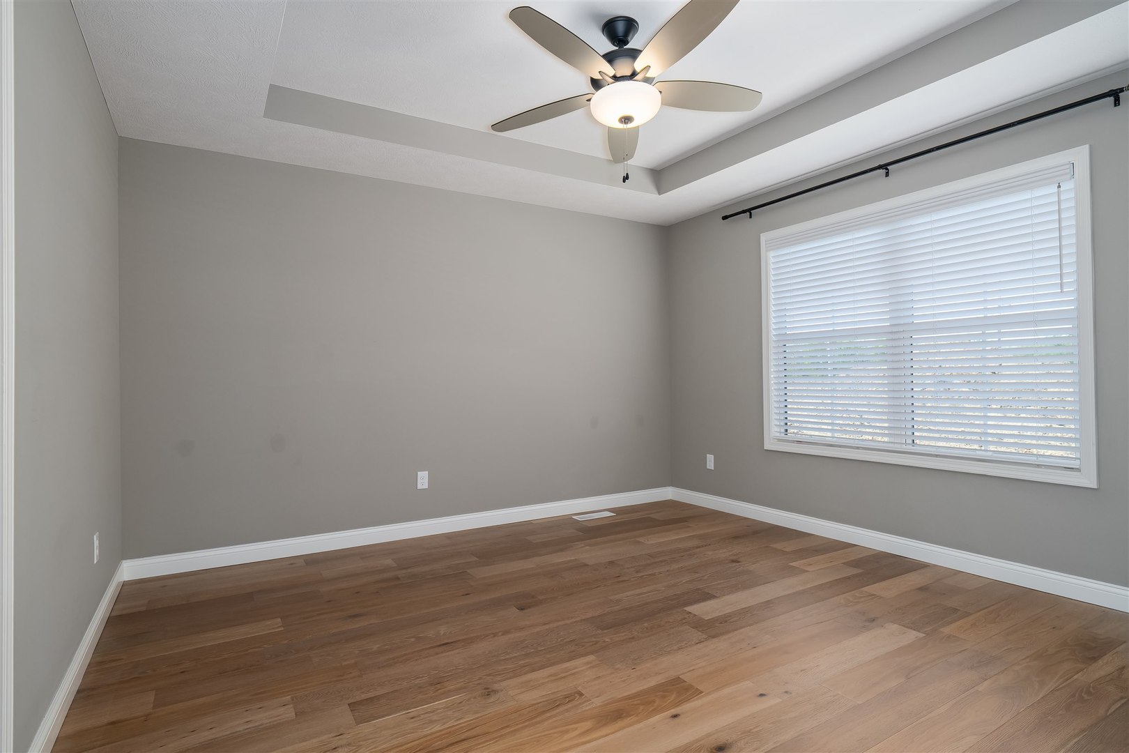 1172 Hershey Road Normal, IL 61761 - Photo 15 of 37 a view of an empty room with wooden floor and a window