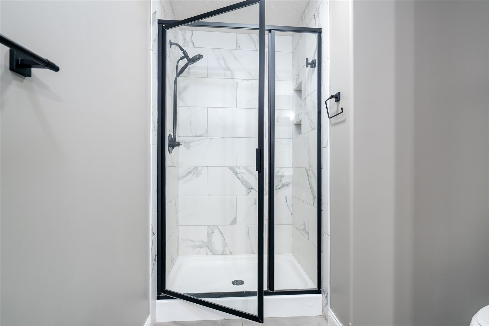 1172 Hershey Road Normal, IL 61761 - Photo 18 of 37 a bathroom with a glass shower door and mirror