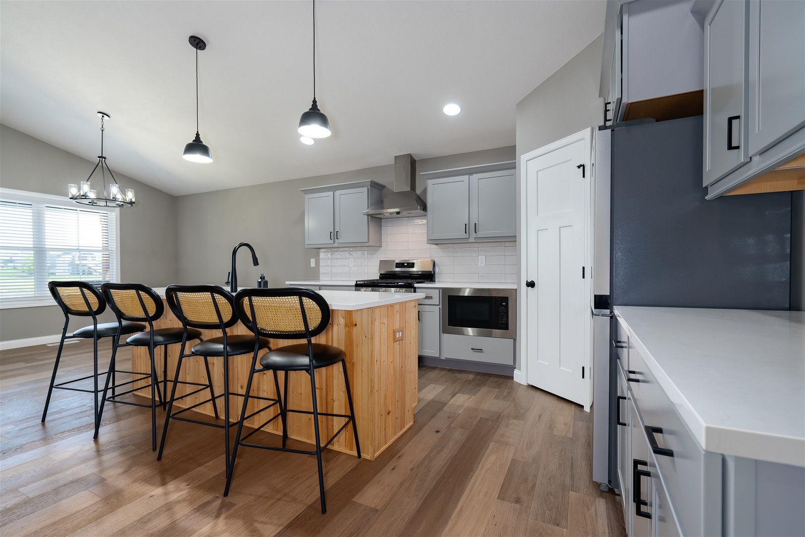 1172 Hershey Road Normal, IL 61761 - Photo 7 of 37 a kitchen with stainless steel appliances a table chairs refrigerator and wooden floor