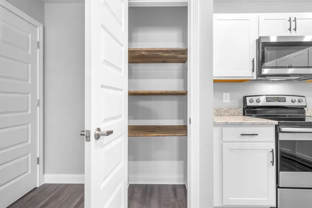 a view of hallway with wooden floor