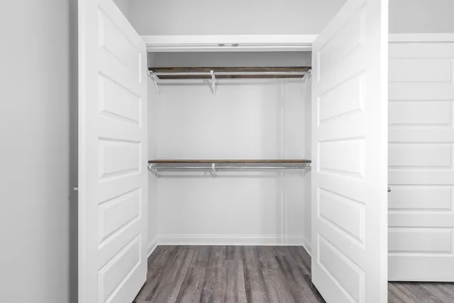 a view of walk in closet with empty racks
