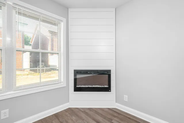 a living room with a fireplace and a floor