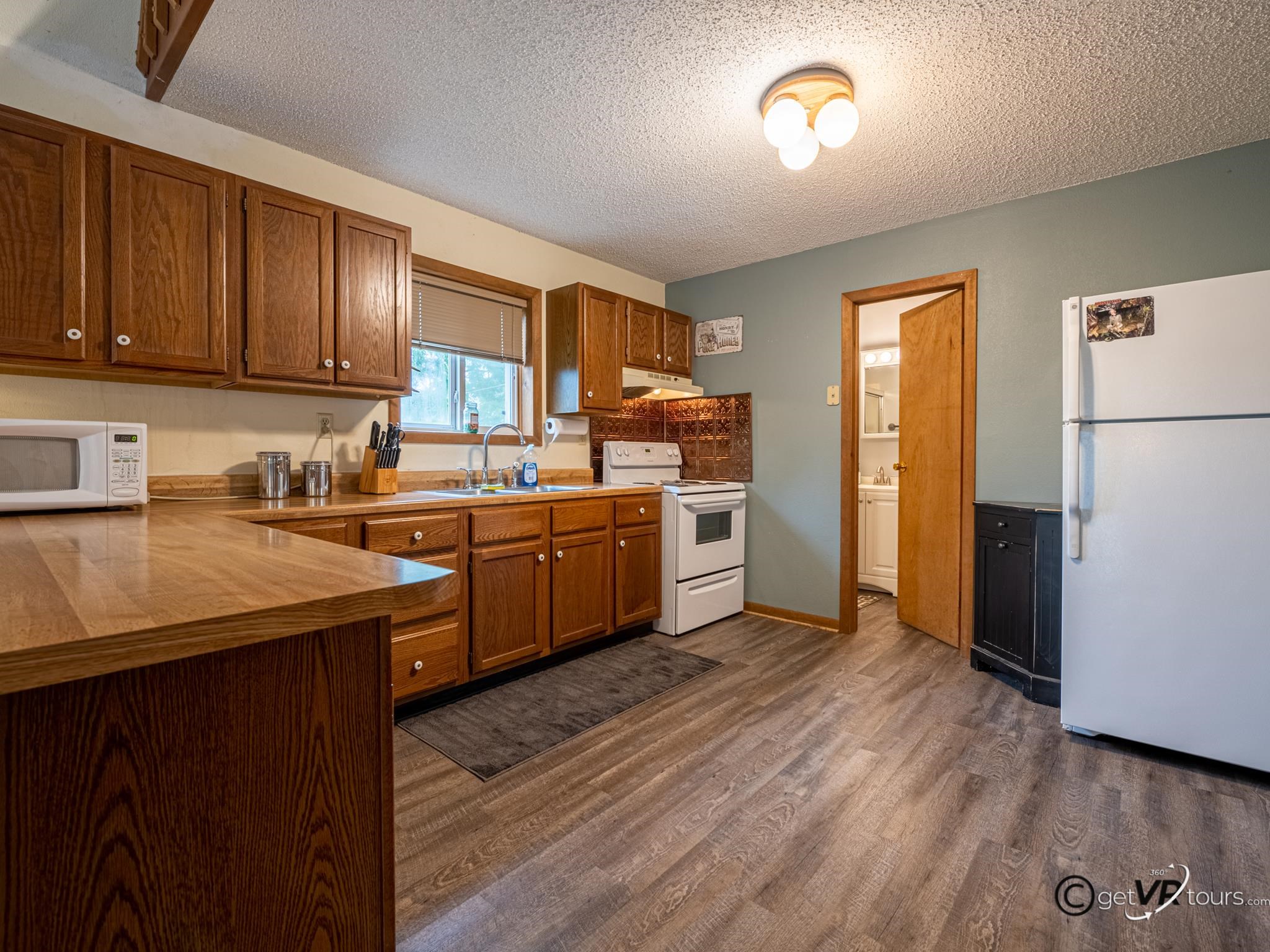 4561 East Welch Road Elizabeth, IL 61028 - Photo 11 of 60 a kitchen with cabinets a sink and appliances