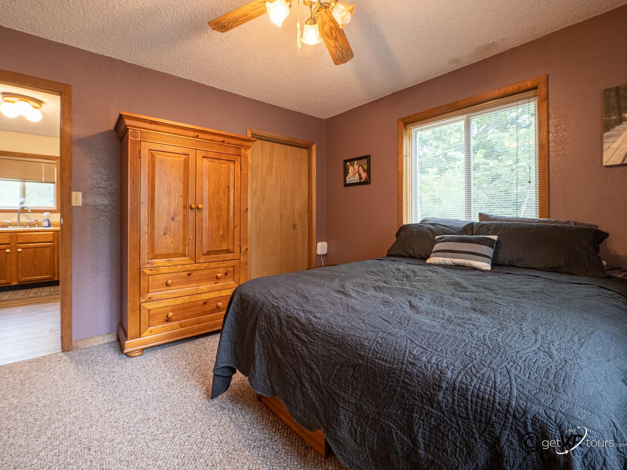 4561 East Welch Road Elizabeth, IL 61028 - Photo 13 of 60 a bedroom with a bed and a window