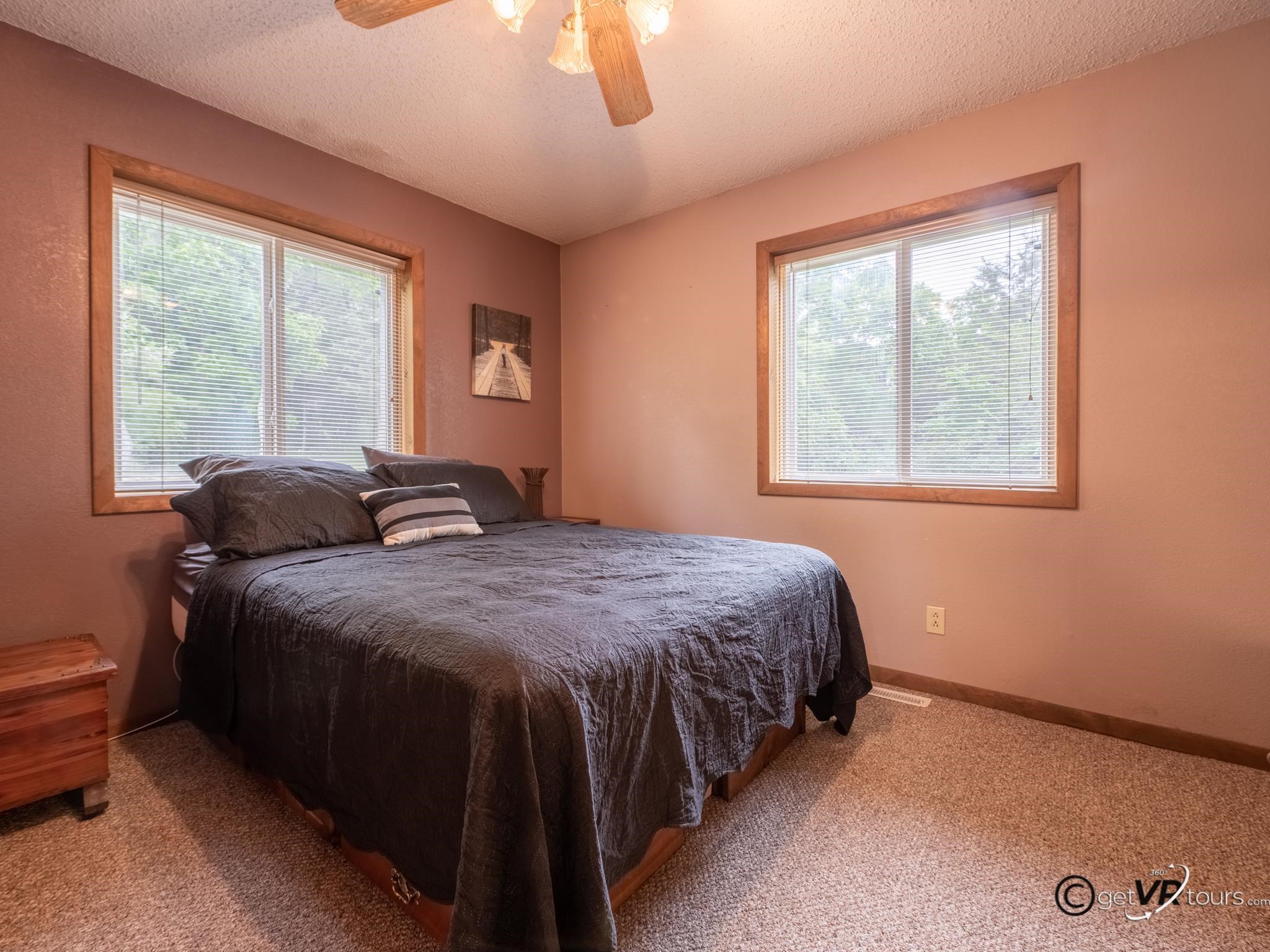 4561 East Welch Road Elizabeth, IL 61028 - Photo 14 of 60 a bed sitting in a bedroom next to a window
