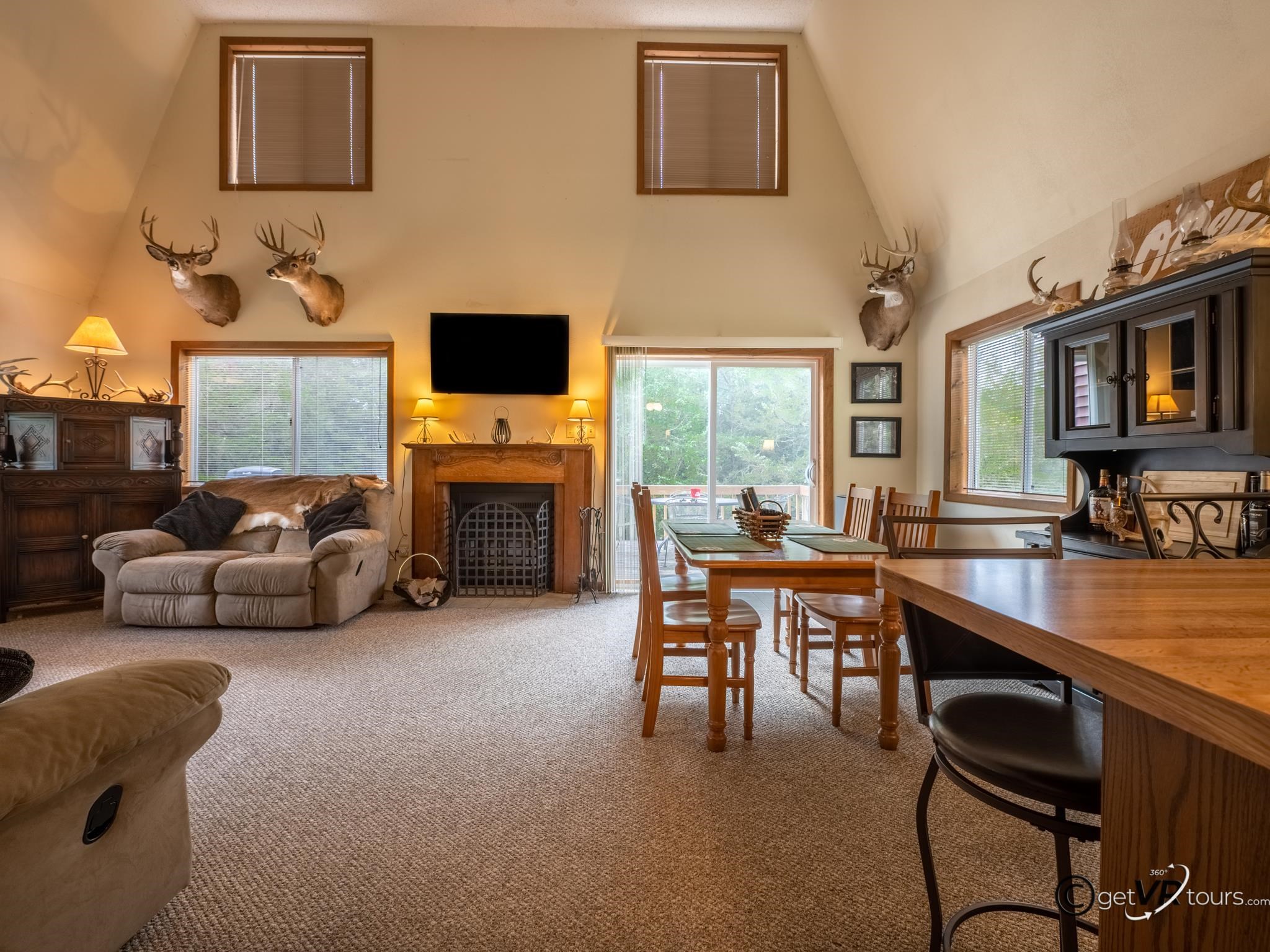 4561 East Welch Road Elizabeth, IL 61028 - Photo 8 of 60 a living room with furniture a fireplace and a flat screen tv