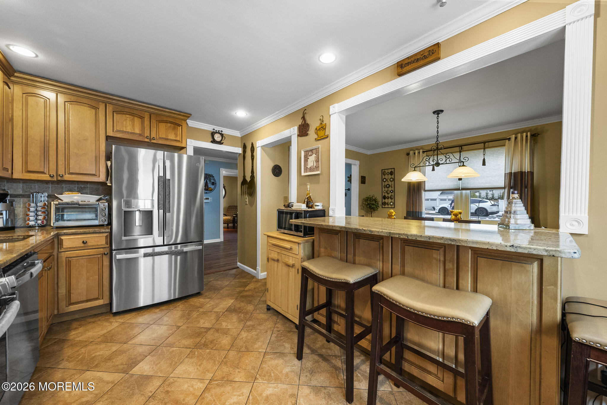 30 Arvin Road Old Bridge, NJ 08857 - Photo 11 of 31 a kitchen with stainless steel appliances granite countertop a refrigerator a stove a sink and a dining table with wooden cabinet