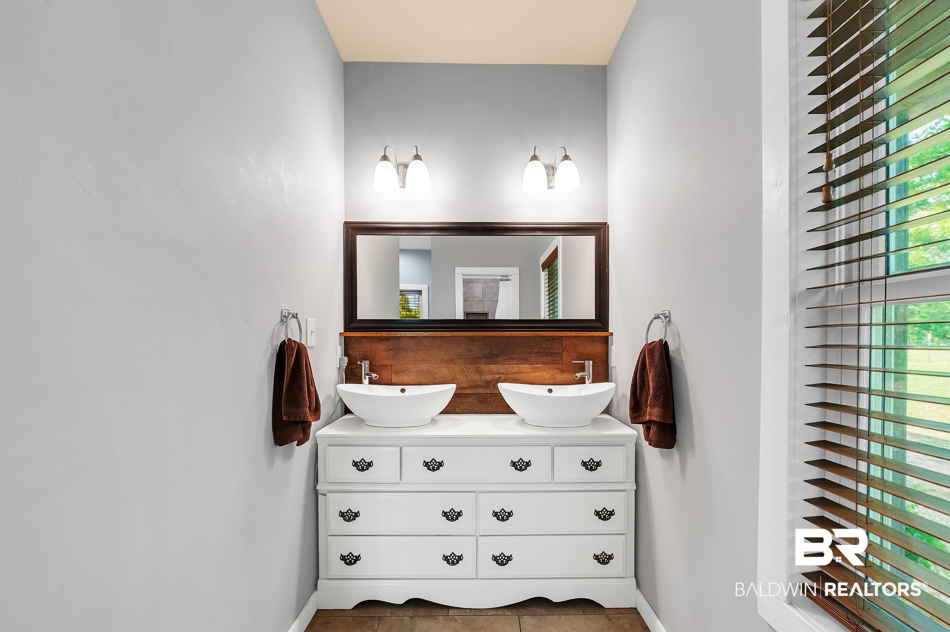 13827 County Road 83 Elberta, AL 36530 - Photo 28 of 38 Bathroom featuring baseboards, double vanity, and tile patterned flooring