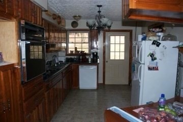 7080 Bolestown Road Alpine, TN 38543 - Photo 6 of 12 a kitchen with a refrigerator and a stove