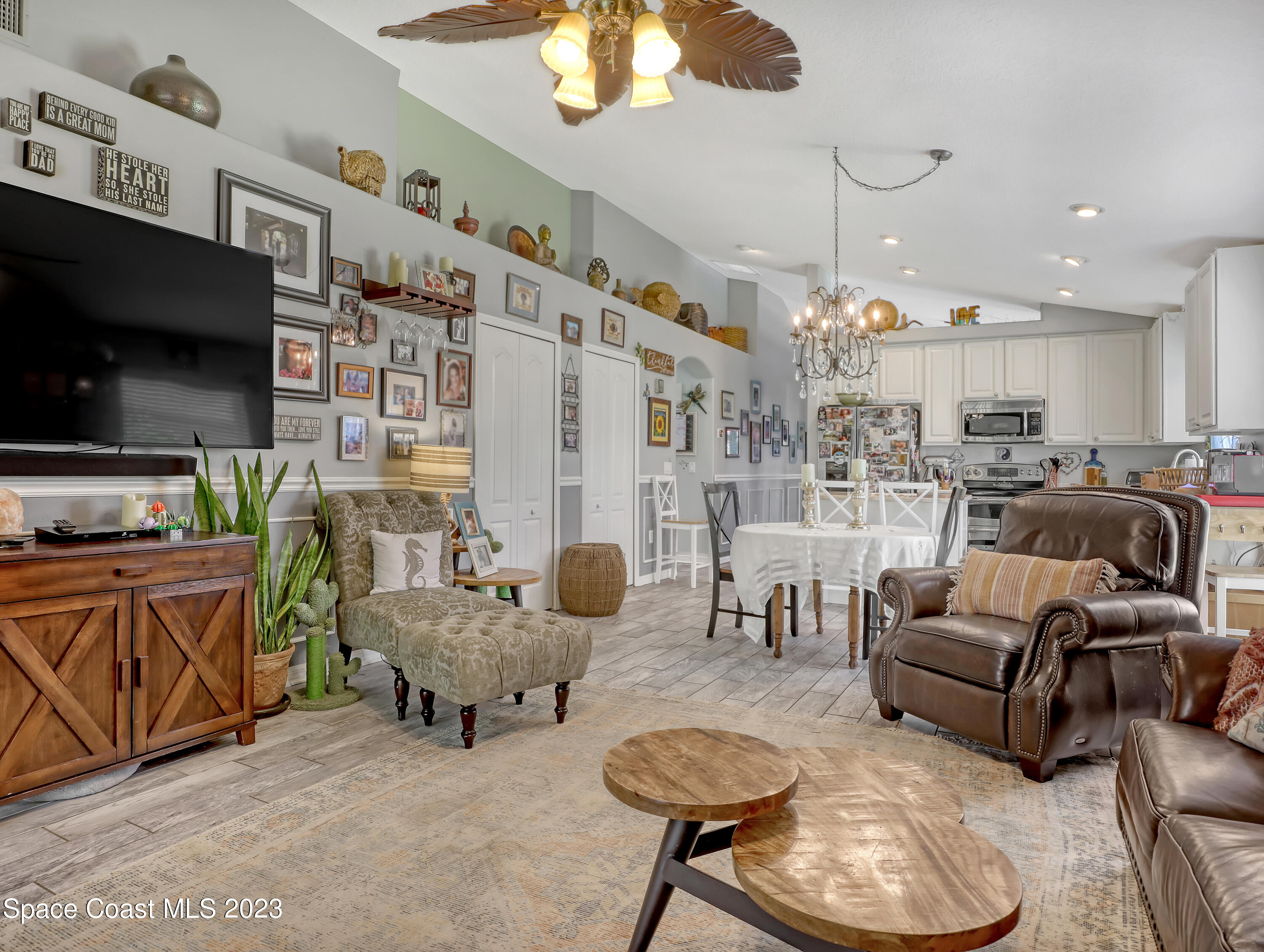 3625 Fodder Drive Rockledge, FL 32955 - Photo 12 of 47 a living room with furniture a flat screen tv and kitchen view
