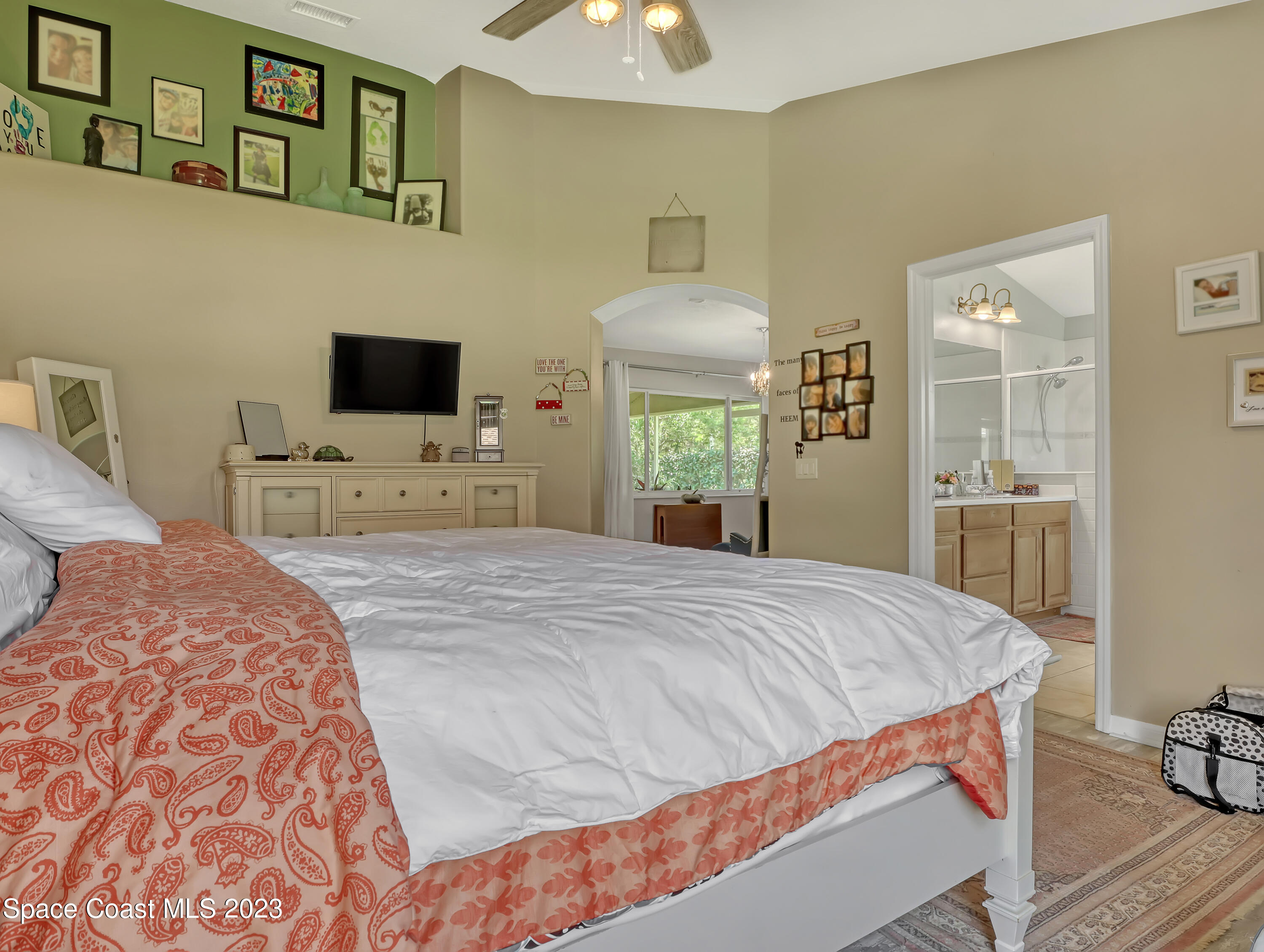 3625 Fodder Drive Rockledge, FL 32955 - Photo 26 of 47 a bedroom with a bed and a flat tv screen on dresser