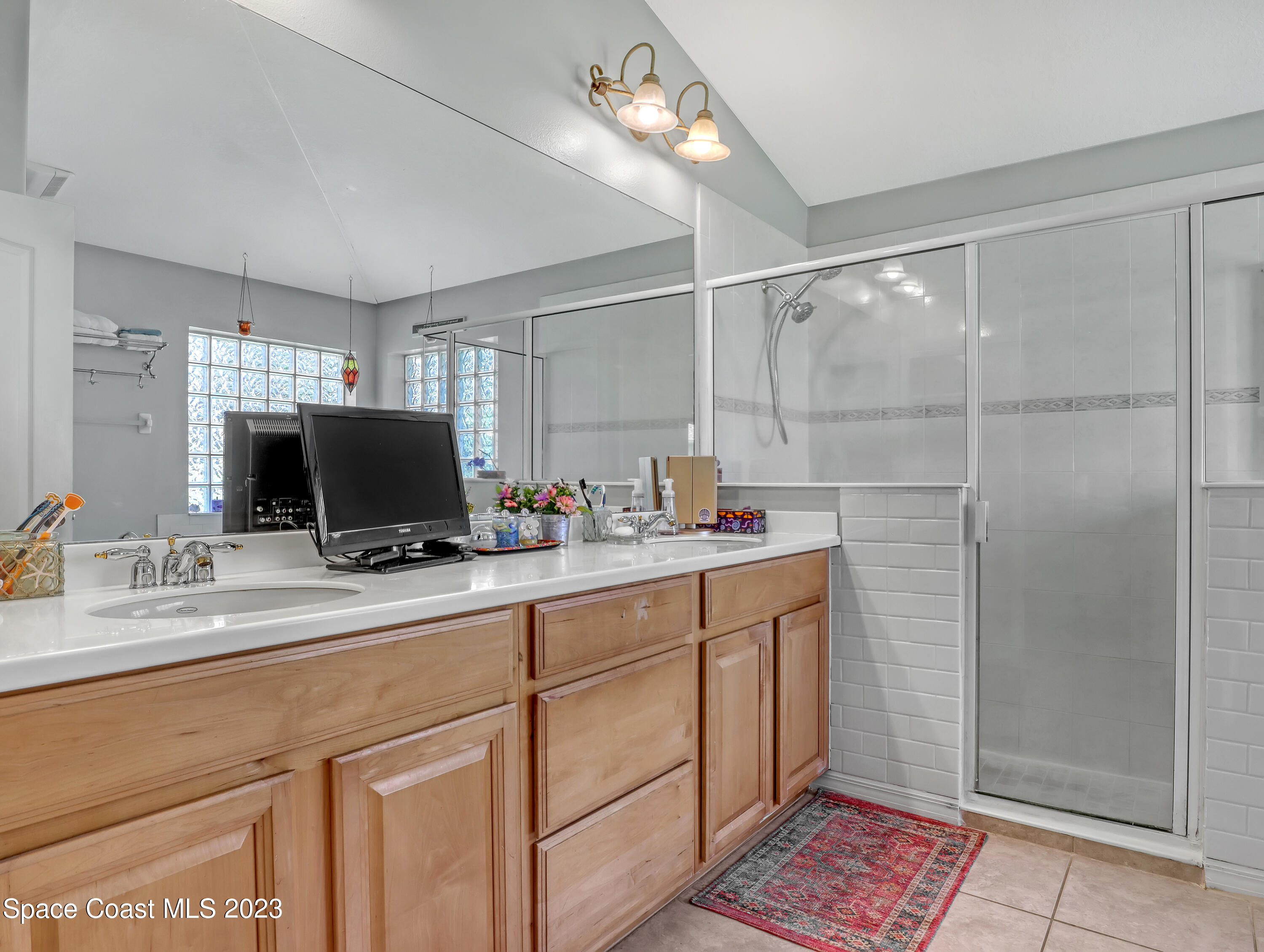 3625 Fodder Drive Rockledge, FL 32955 - Photo 27 of 47 a bathroom with a double vanity sink and a mirror