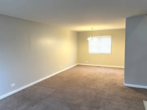 an empty room with a empty space and a window