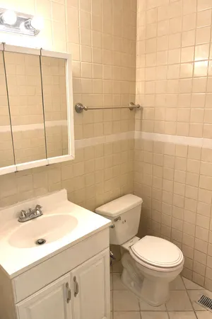 a bathroom with a sink a toilet and a mirror