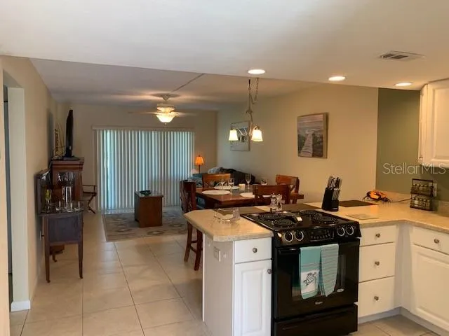 a view of a kitchen with a sink stainless steel appliances and cabinets