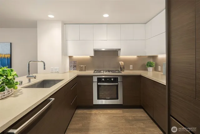 a kitchen with a sink cabinets and wooden floor