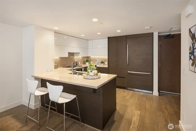 a living room with furniture fireplace and wooden floor