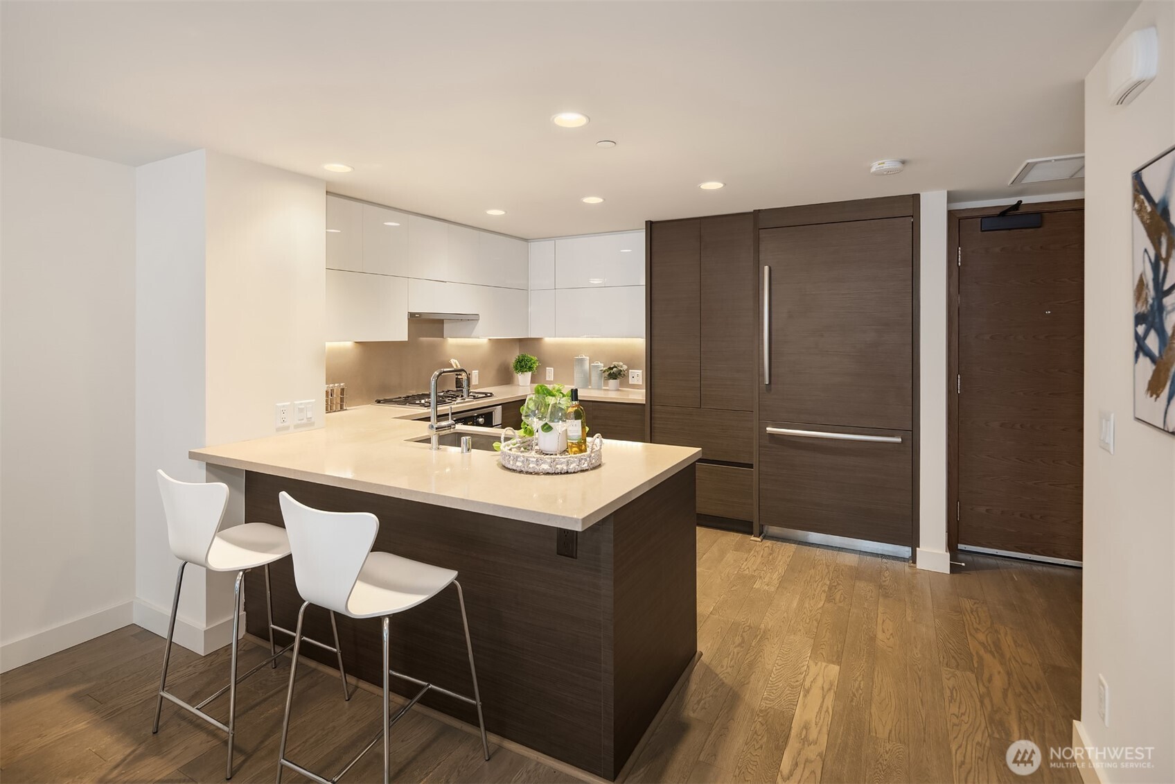 588 Bell Street, Unit 214S Seattle, WA 98121 - Photo 12 of 40 a kitchen with a sink cabinets and wooden floor
