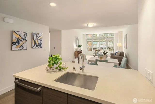 a kitchen with kitchen island stainless steel appliances a sink and counter space