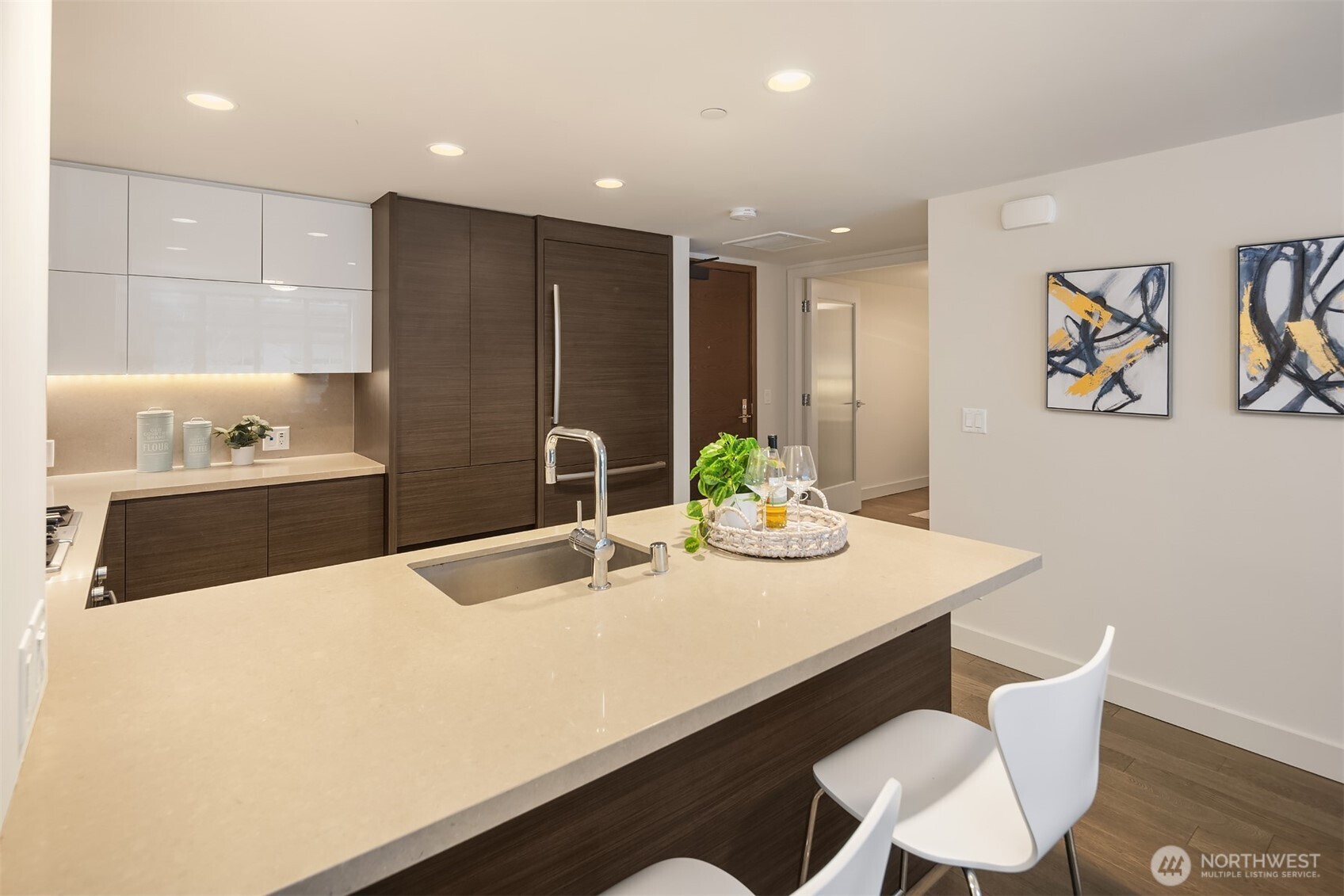 588 Bell Street, Unit 214S Seattle, WA 98121 - Photo 15 of 40 a kitchen with kitchen island stainless steel appliances a sink and counter space