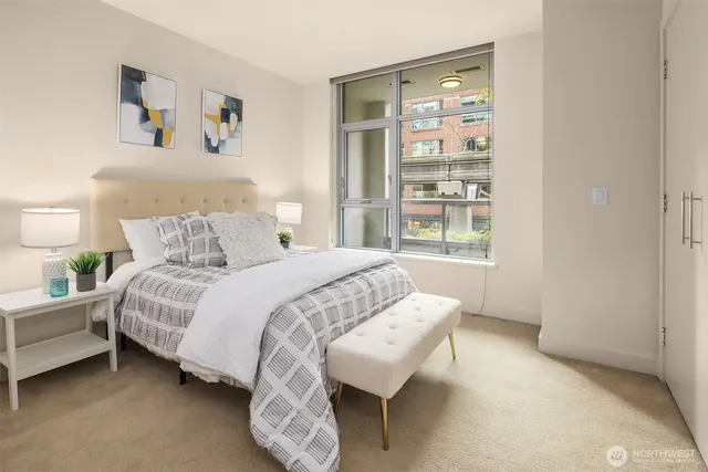 a bedroom with a bed and a window