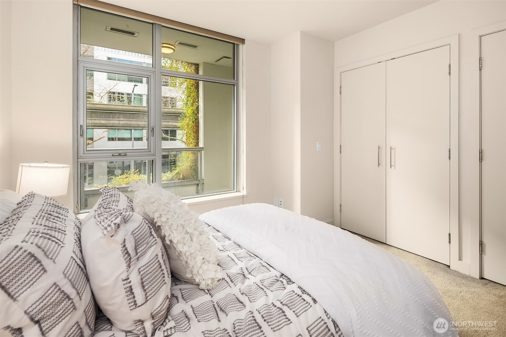 588 Bell Street, Unit 214S Seattle, WA 98121 - Photo 20 of 40 a bedroom with a bed and a window