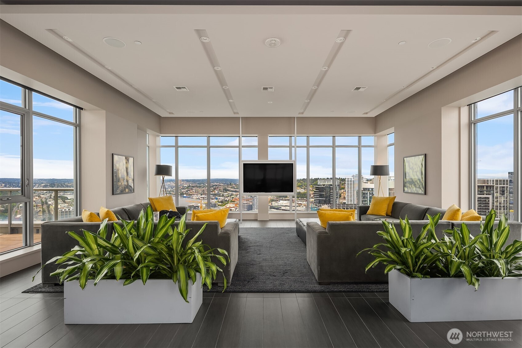 588 Bell Street, Unit 214S Seattle, WA 98121 - Photo 32 of 40 a living room with furniture potted plant floor to ceiling window and a flat screen tv