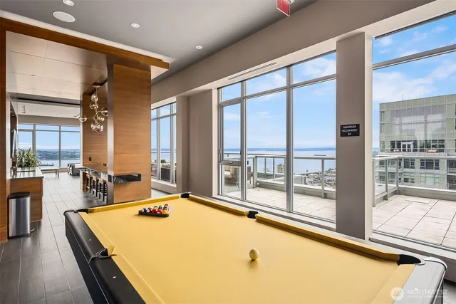 a view of a living room and kitchen with a large window