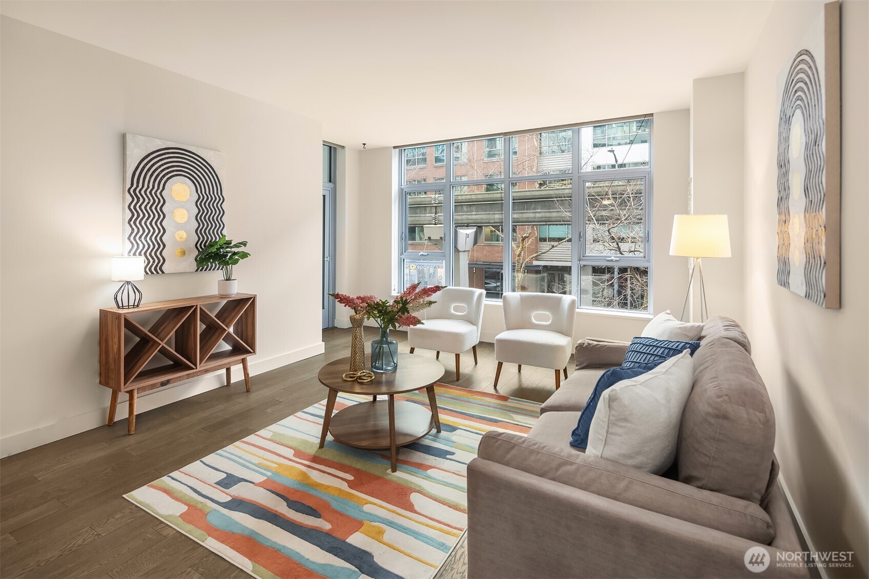 588 Bell Street, Unit 214S Seattle, WA 98121 - Photo 7 of 40 a living room with furniture and a floor to ceiling window