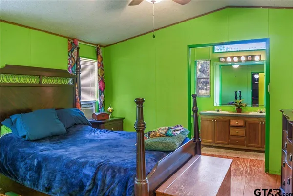 a bedroom with a bed and a dresser