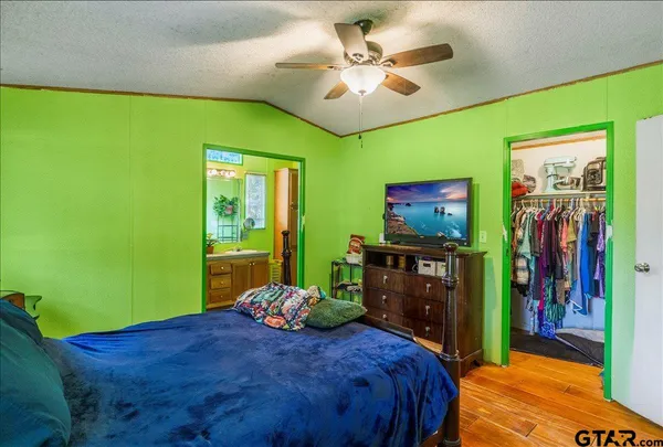a bedroom with a bed and a flat screen tv