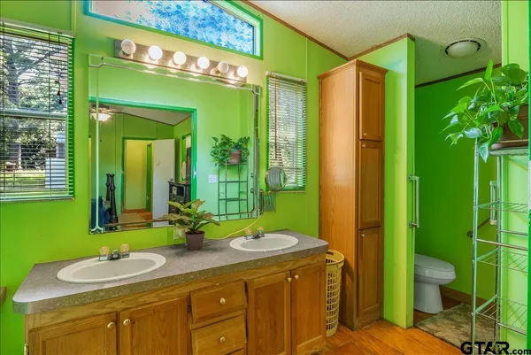 a bathroom with a sink mirror toilet and shower
