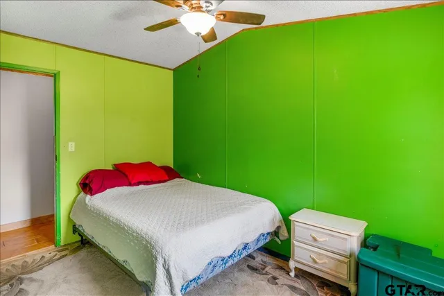 a bedroom with a bed and a dresser