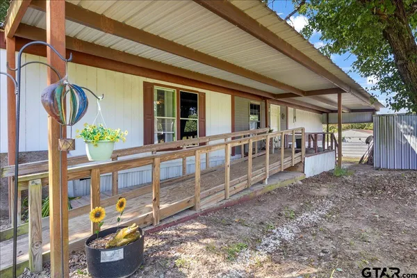 a view of an chairs and table in the backyard
