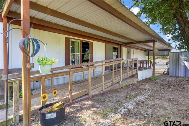 a view of an chairs and table in the backyard