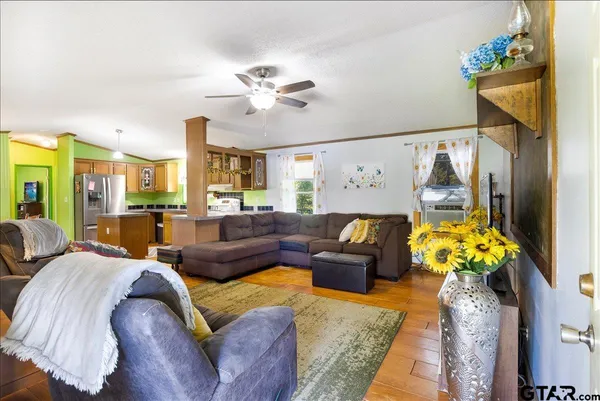 a living room with furniture flowers and a chandelier