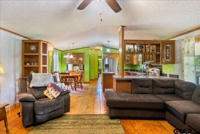a living room with furniture and large windows