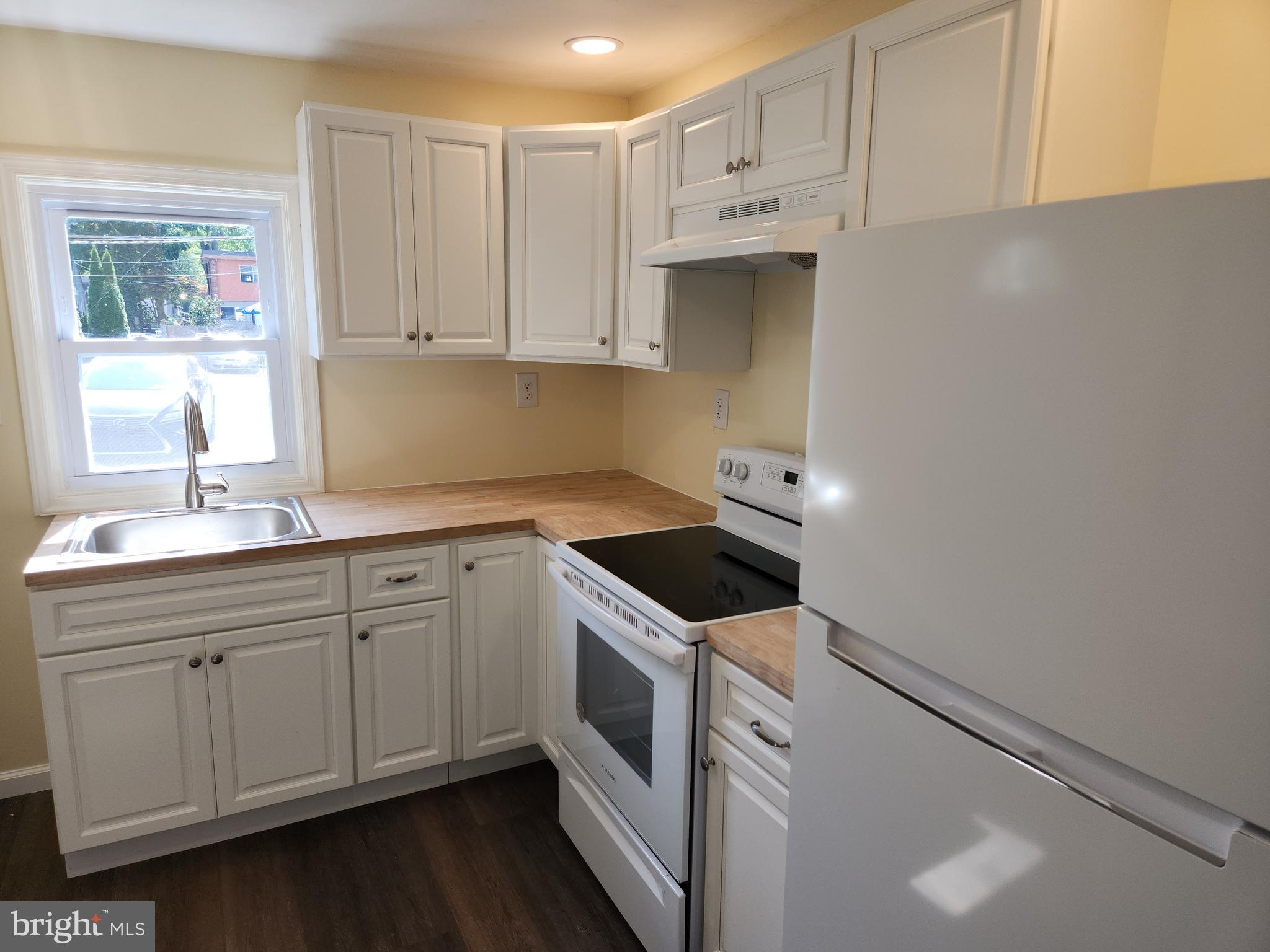 714-716 Revolution Street Havre de Grace, MD 21078 - Photo 13 of 16 a kitchen with granite countertop white cabinets and white appliances