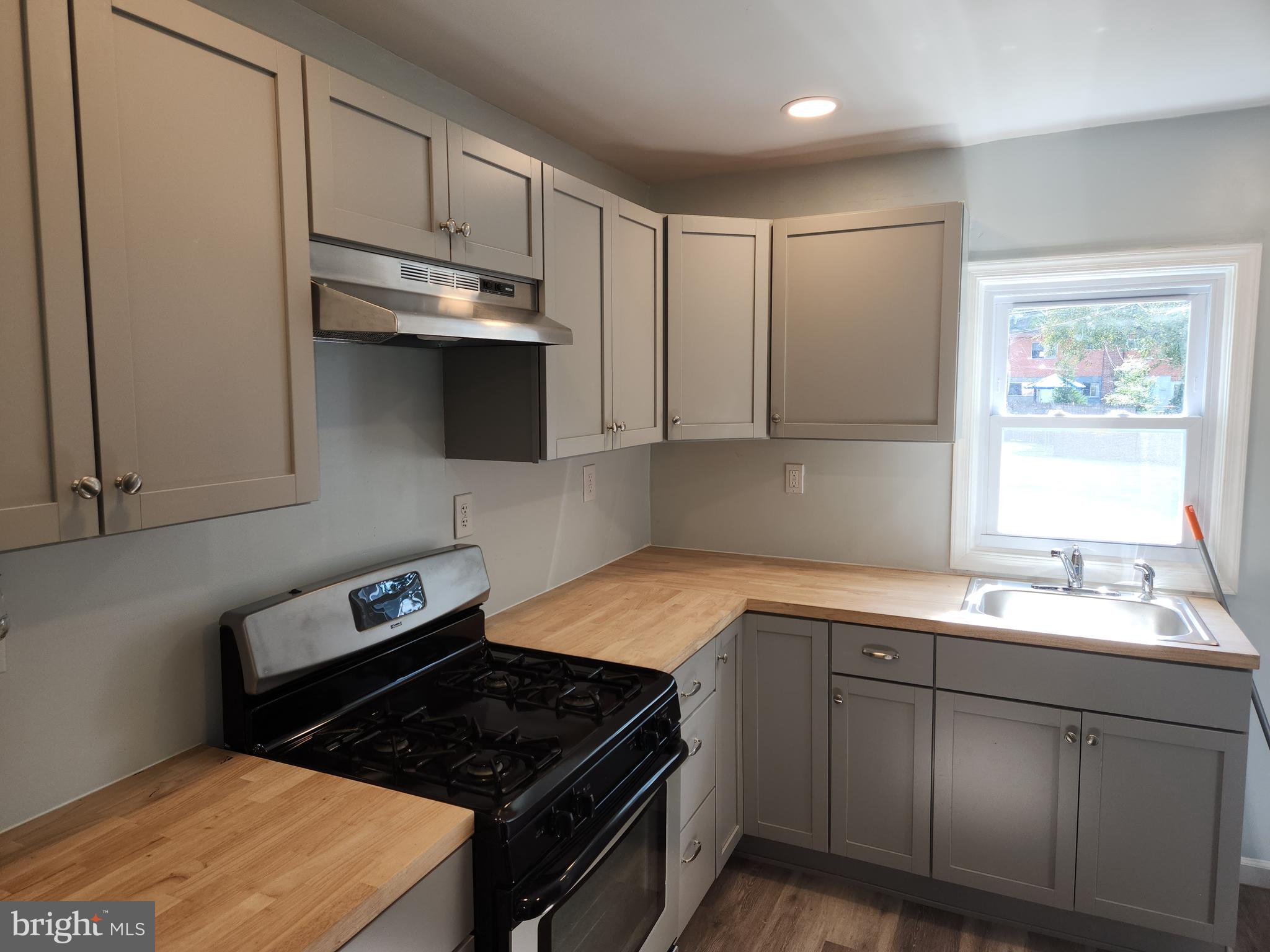 714-716 Revolution Street Havre de Grace, MD 21078 - Photo 4 of 16 a kitchen with a sink stove and cabinets