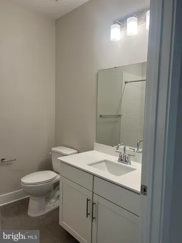 a bathroom with a sink toilet and a mirror