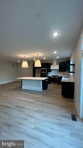 a view of kitchen with kitchen island microwave and stove