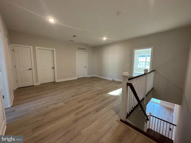 a view of a livingroom with wooden floor and window